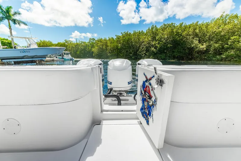 Slide: The Image of 2017 SeaHunter 35 Tournament boat with pirate-themed storage, docked near lush greenery. - 8