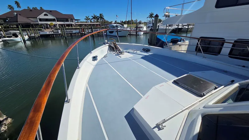 Slide: The Image of 1987 DeFever 48 Tri Cabin yacht docked in marina. - 10