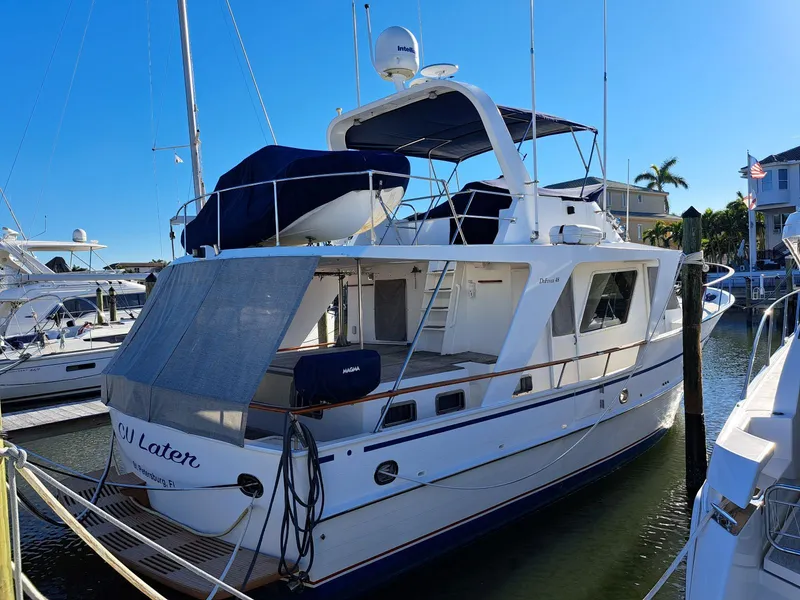 Slide: The Image of 1987 DeFever 48 Tri Cabin yacht docked at marina. - 2