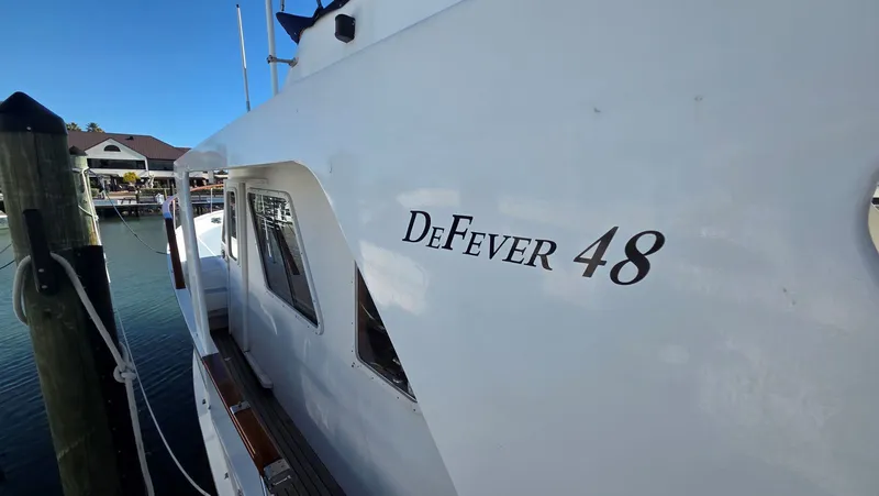 Slide: The Image of 1987 DeFever 48 Tri Cabin yacht docked at marina. - 20