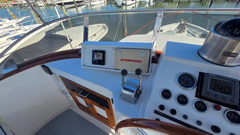 Slide: The Image of 1987 DeFever 48 Tri Cabin yacht helm station in harbor. - 23