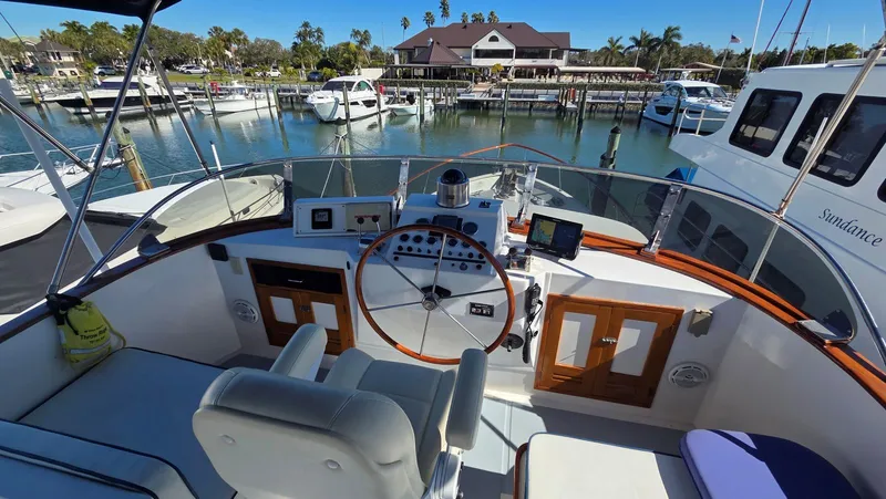 Slide: The Image of DeFever 48 Tri Cabin 1987 helm with marina view. - 27