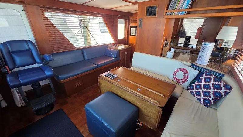 Slide: The Image of Interior of 1987 DeFever 48 Tri Cabin yacht, featuring cozy seating area. - 28