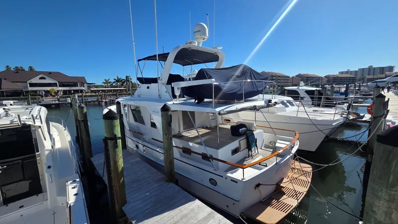 Slide: The Image of 1987 DeFever 48 Tri Cabin yacht docked at marina. - 3