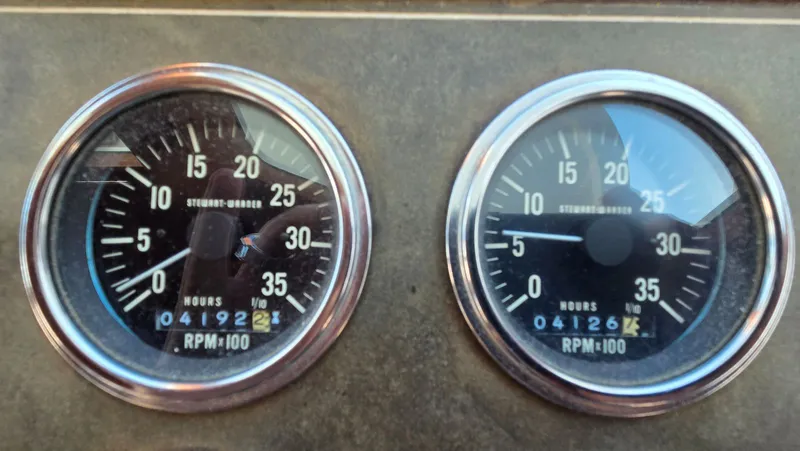 Slide: The Image of DeFever 48 Tri Cabin 1987 tachometer gauges displaying engine hours. - 37