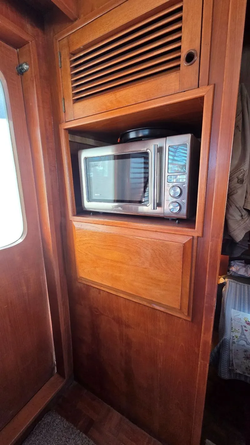 Slide: The Image of Microwave in wooden cabinet on 1987 DeFever 48 Tri Cabin yacht. - 45