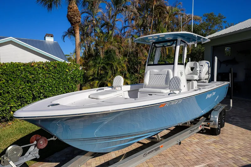The Image of 2023 Sportsman Masters 267 Bay Boat on trailer, parked in sunny driveway. - 0