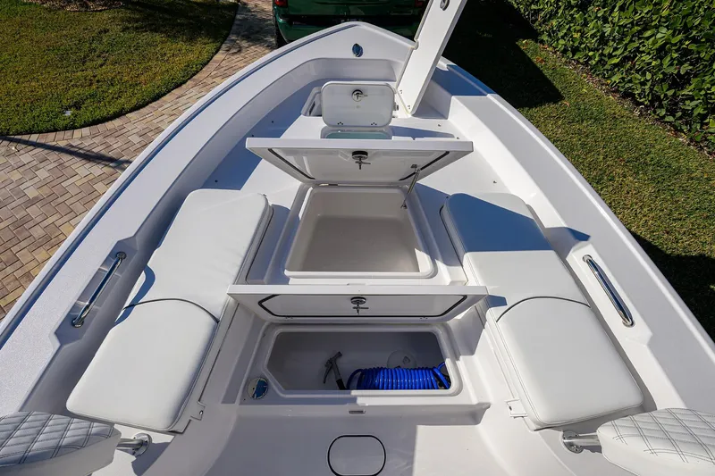 Slide: The Image of 2023 Sportsman Masters 267 Bay Boat interior with open storage compartments and seating. - 10