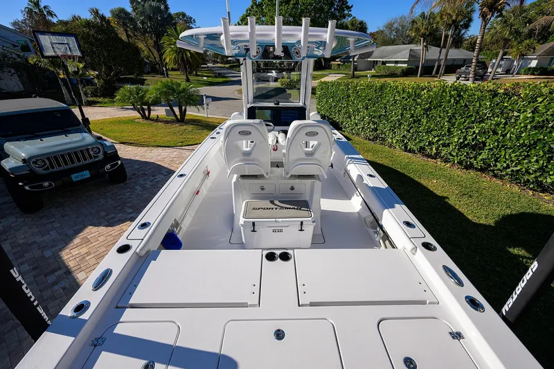 Slide: The Image of 2023 Sportsman Masters 267 Bay Boat parked in a residential driveway, showcasing sleek design. - 19