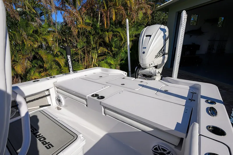 Slide: The Image of 2023 Sportsman Masters 267 Bay Boat with Yamaha engine, docked near lush greenery. - 20