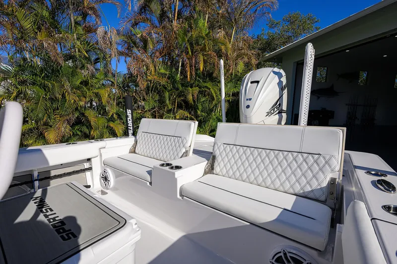 Slide: The Image of 2023 Sportsman Masters 267 Bay Boat interior with white seating and Yamaha engine. - 23