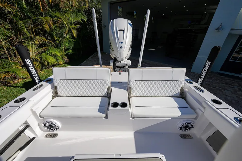 Slide: The Image of 2023 Sportsman Masters 267 Bay Boat interior with white seating and modern design. - 24