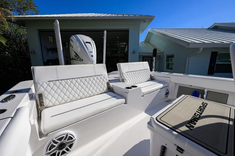 Slide: The Image of 2023 Sportsman Masters 267 Bay Boat with white seating and Yamaha engine in a sunny setting. - 25