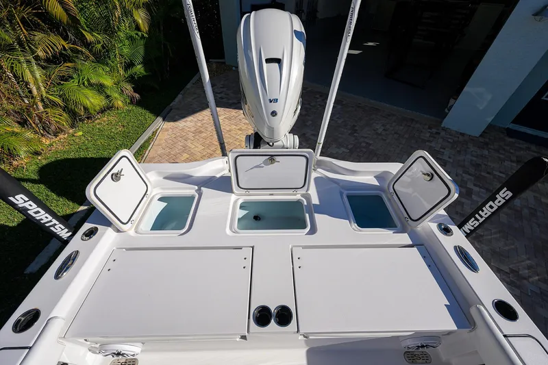 Slide: The Image of 2023 Sportsman Masters 267 Bay Boat with open storage compartments and powerful V8 engine. - 26