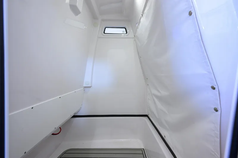 Slide: The Image of Interior cabin of 2023 Sportsman Masters 267 Bay Boat, featuring sleek white design. - 29
