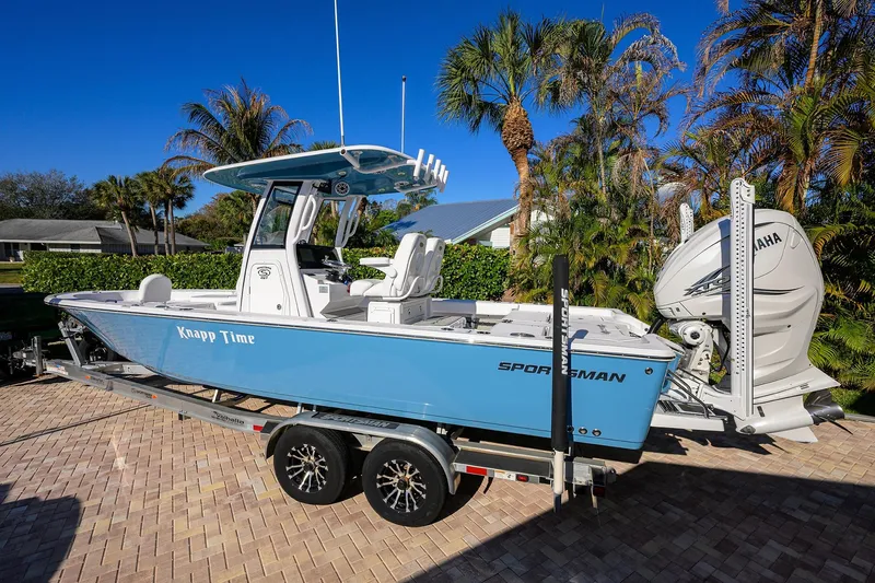Slide: The Image of 2023 Sportsman Masters 267 Bay Boat on trailer, parked with palm trees in background. - 3