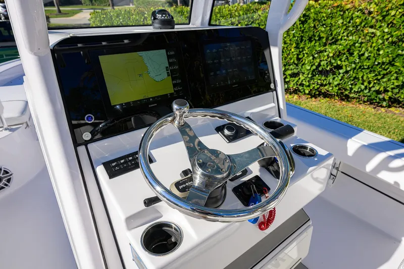 Slide: The Image of 2023 Sportsman Masters 267 Bay Boat helm with steering wheel and navigation display. - 35