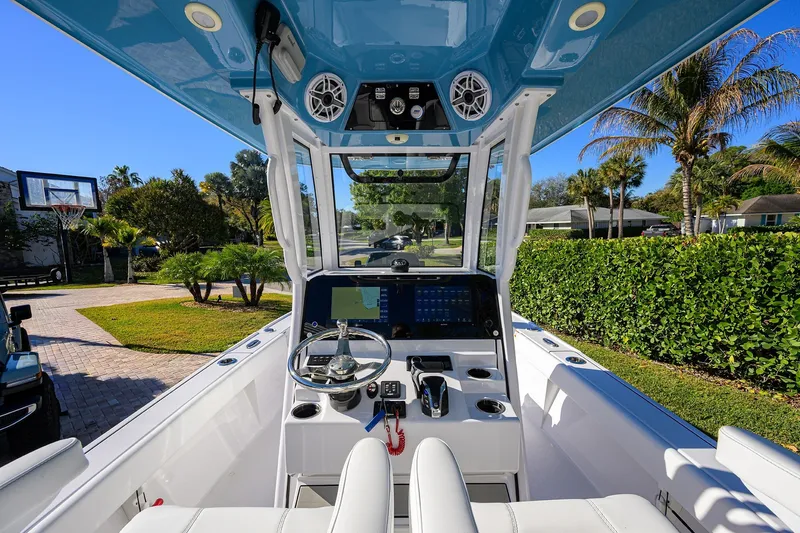 Slide: The Image of 2023 Sportsman Masters 267 Bay Boat interior with modern dashboard and steering wheel. - 36
