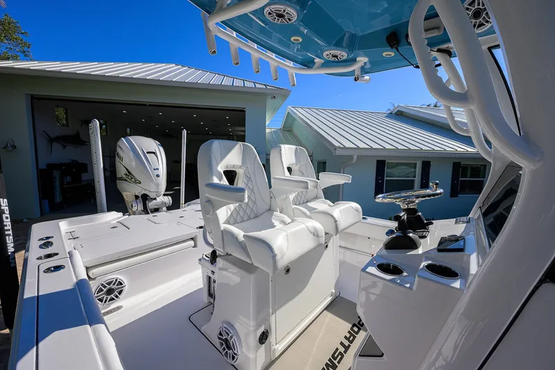 Slide: The Image of 2023 Sportsman Masters 267 Bay Boat interior with white seating and modern controls. - 39
