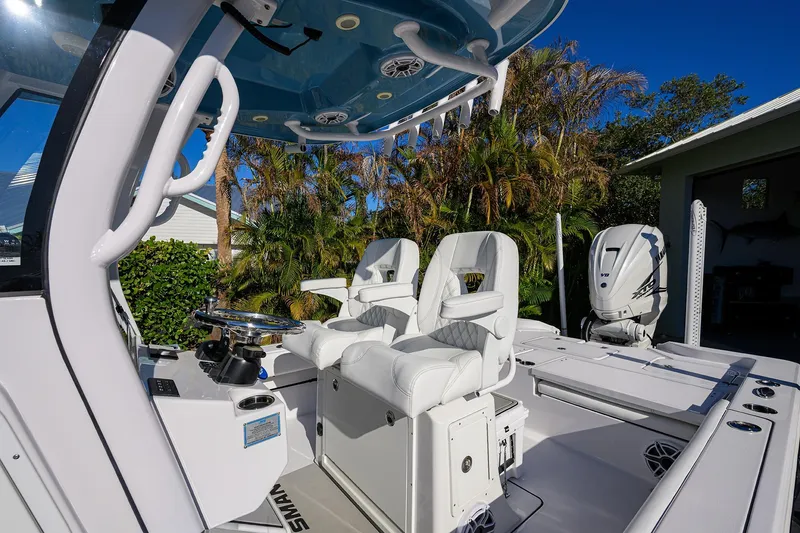 Slide: The Image of 2023 Sportsman Masters 267 Bay Boat interior with white seating and modern controls. - 40