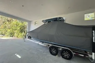 Slide: The Image of 2023 Sportsman Masters 267 Bay Boat covered in a garage, showcasing sleek design. - 45