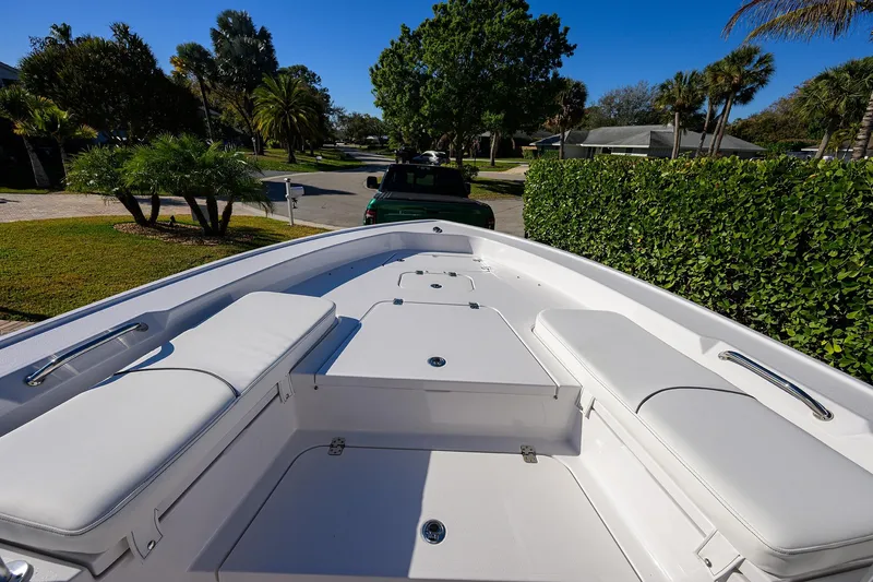 Slide: The Image of 2023 Sportsman Masters 267 Bay Boat with white seating, parked in a suburban neighborhood. - 7