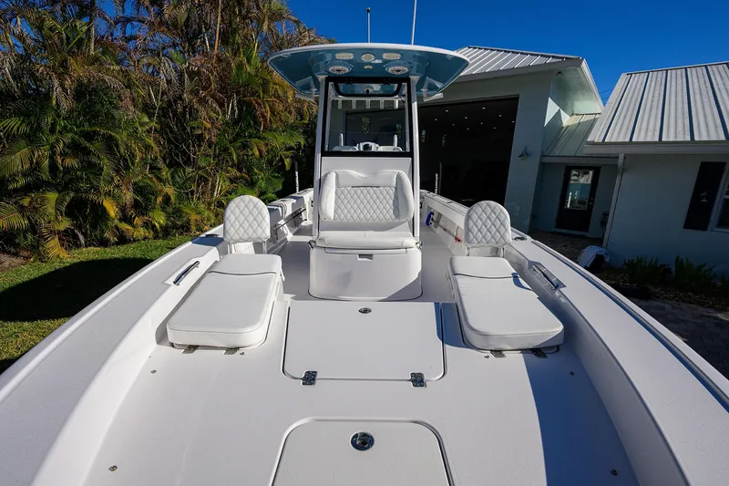 Slide: The Image of 2023 Sportsman Masters 267 Bay Boat with white seating and sleek design. - 8