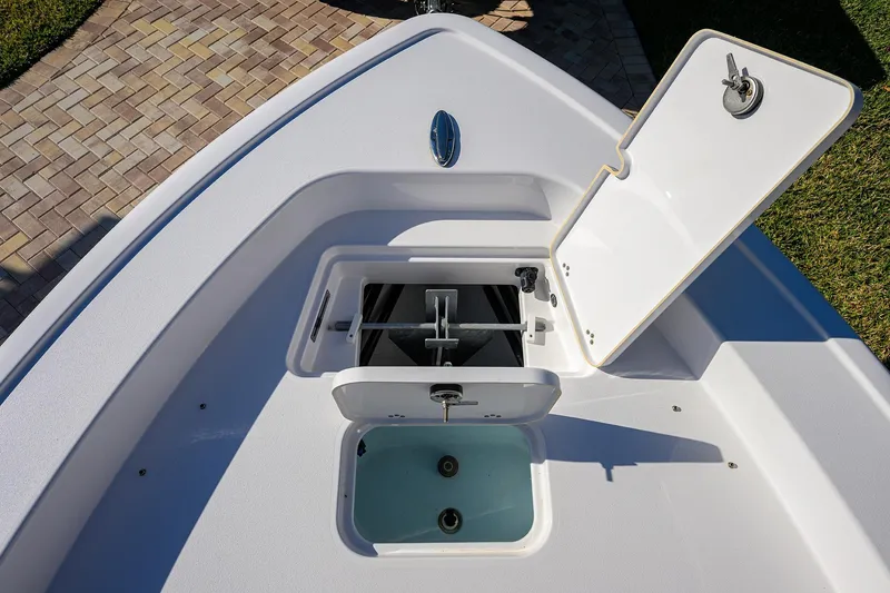 Slide: The Image of 2023 Sportsman Masters 267 Bay Boat anchor storage compartment, open lid, top view. - 9