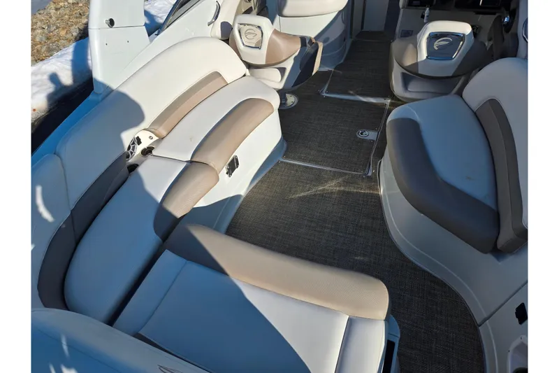 Slide: The Image of 2018 Crownline 275 SS boat interior with beige and gray seating, carpeted floor. - 11