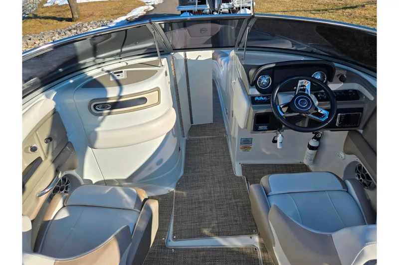 Slide: The Image of 2018 Crownline 275 SS boat interior with steering wheel and seating area. - 13
