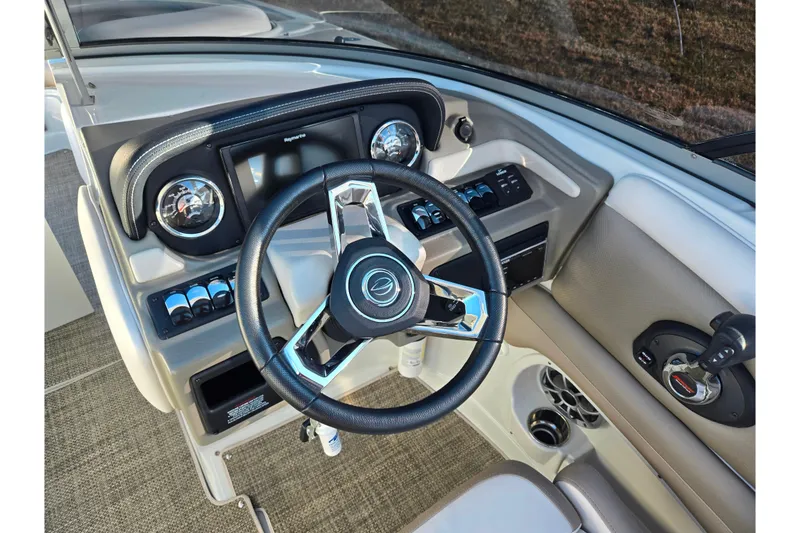 Slide: The Image of 2018 Crownline 275 SS boat dashboard with steering wheel and controls. - 14