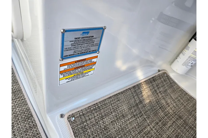 Slide: The Image of 2018 Crownline 275 SS yacht certification and safety warning labels on interior panel. - 15