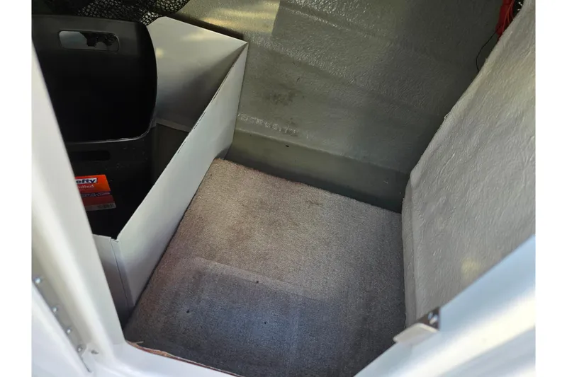 Slide: The Image of Interior storage compartment of 2018 Crownline 275 SS boat with carpeted flooring. - 18