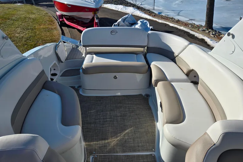 Slide: The Image of 2018 Crownline 275 SS boat interior with beige seating and carpeted floor. - 24