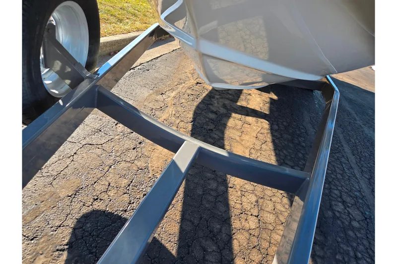 Slide: The Image of 2018 Crownline 275 SS boat on trailer, showing hull and trailer frame. - 7