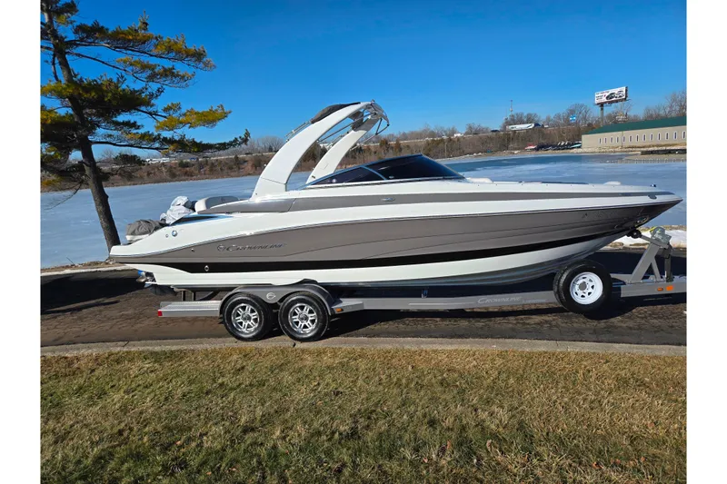 Slide: The Image of 2018 Crownline 275 SS boat on trailer by a frozen lake, clear blue sky. - 9