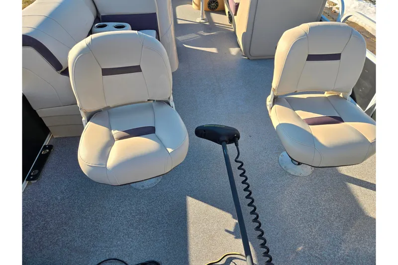 Slide: The Image of 2018 Sun Tracker Bass Buggy 18 DLX interior with beige seating and steering controls. - 13