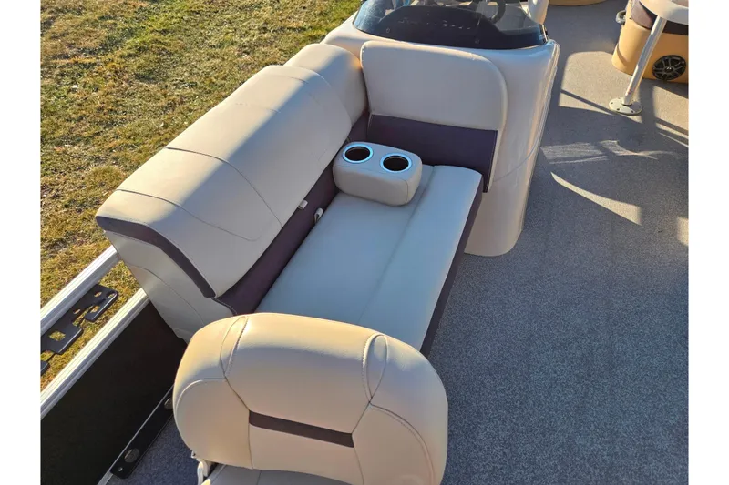 Slide: The Image of 2018 Sun Tracker Bass Buggy 18 DLX boat interior with beige seating and cup holders. - 15