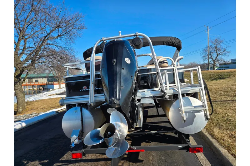 Slide: The Image of 2018 Sun Tracker Bass Buggy 18 DLX pontoon boat on trailer, rear view. - 2