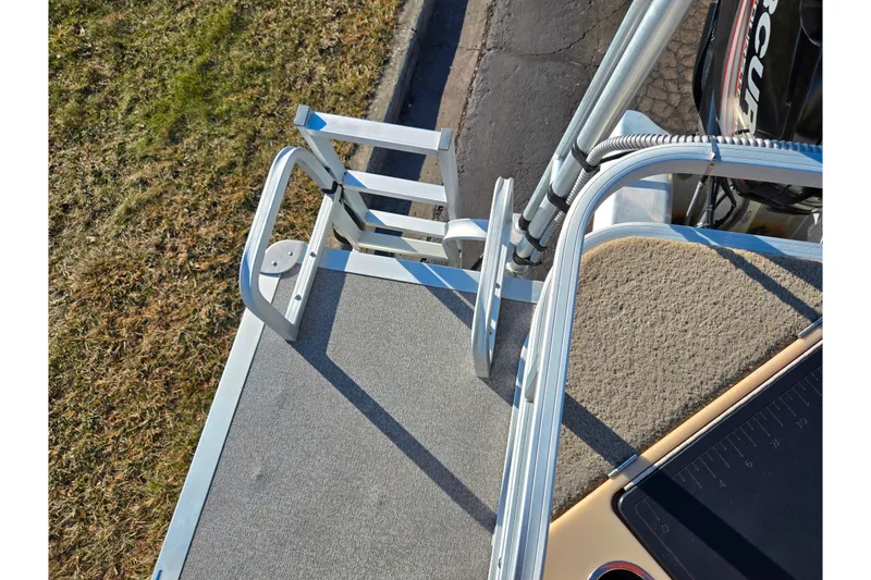 Slide: The Image of 2018 Sun Tracker Bass Buggy 18 DLX boat ladder and deck, viewed from above. - 23