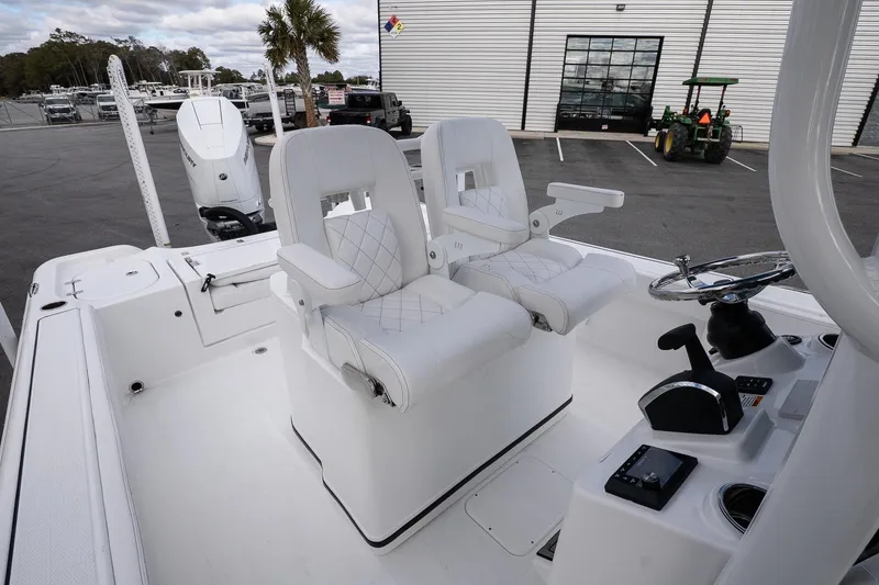 Slide: The Image of 2026 Blazer Bay Makaira 2800 boat interior with dual captain's chairs and control console. - 14