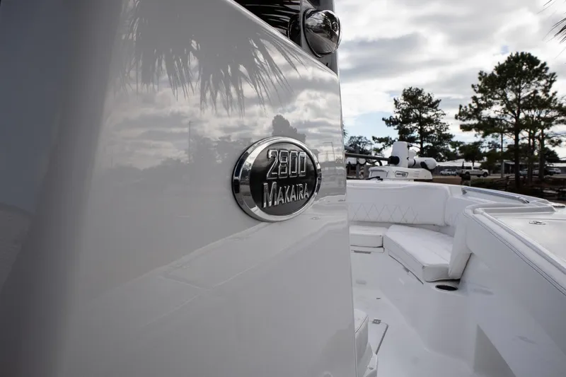 Slide: The Image of 2026 Blazer Bay Makaira 2800 boat, sleek design with logo, outdoor setting. - 15