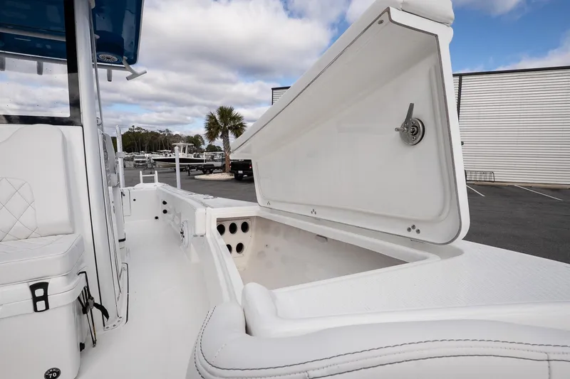 Slide: The Image of 2026 Blazer Bay Makaira 2800 boat with open storage compartment, white interior, and sleek design. - 20