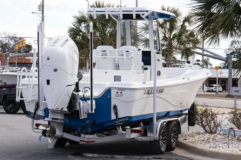 Slide: The Image of 2026 Blazer Bay Makaira 2800 boat on trailer, featuring sleek design and powerful engine. - 25
