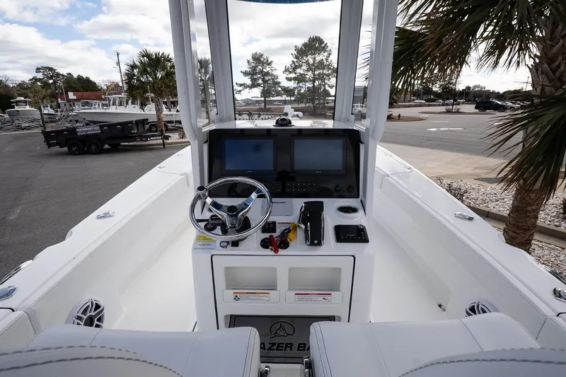 Slide: The Image of 2026 Blazer Bay Makaira 2800 boat cockpit with steering wheel and navigation screens. - 27