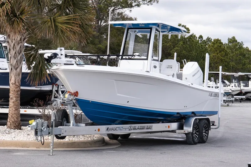 Slide: The Image of 2026 Blazer Bay Makaira 2800 boat on trailer, parked near palm tree. - 3