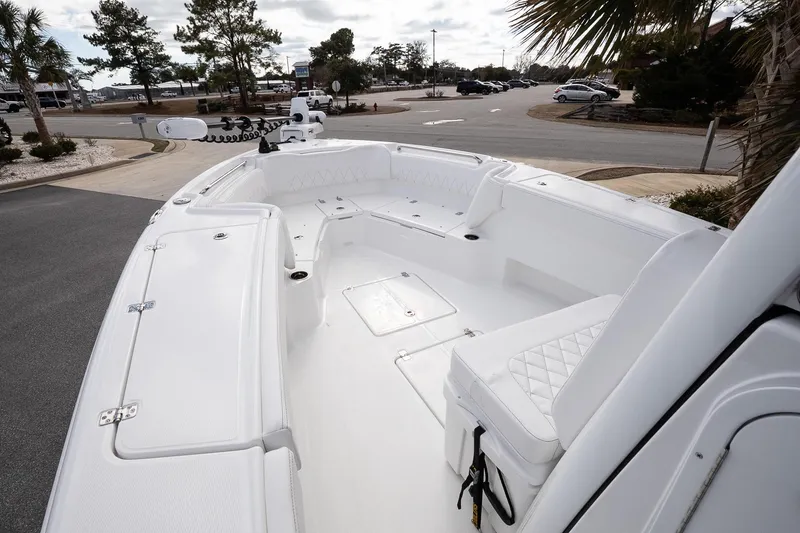 Slide: The Image of 2026 Blazer Bay Makaira 2800 boat interior with white seating and storage compartments. - 35