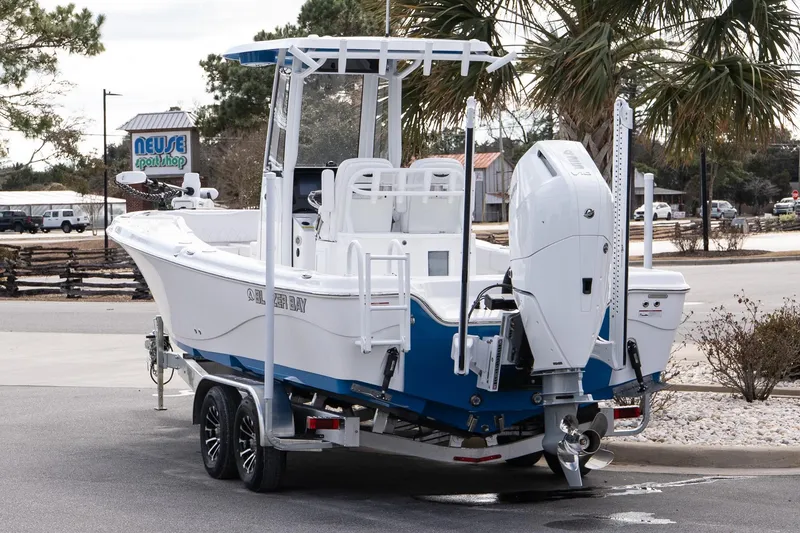 Slide: The Image of 2026 Blazer Bay Makaira 2800 boat on trailer, parked near Neuse Sport Shop. - 5