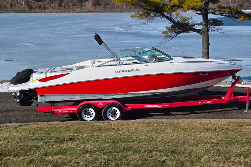The Image of 2007 Rinker 262 Captiva Cuddy boat on trailer by frozen lake. - 0