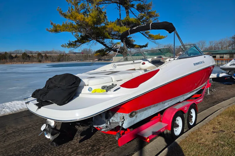 Slide: The Image of 2007 Rinker 262 Captiva Cuddy boat on trailer by frozen lake, sunny day. - 1